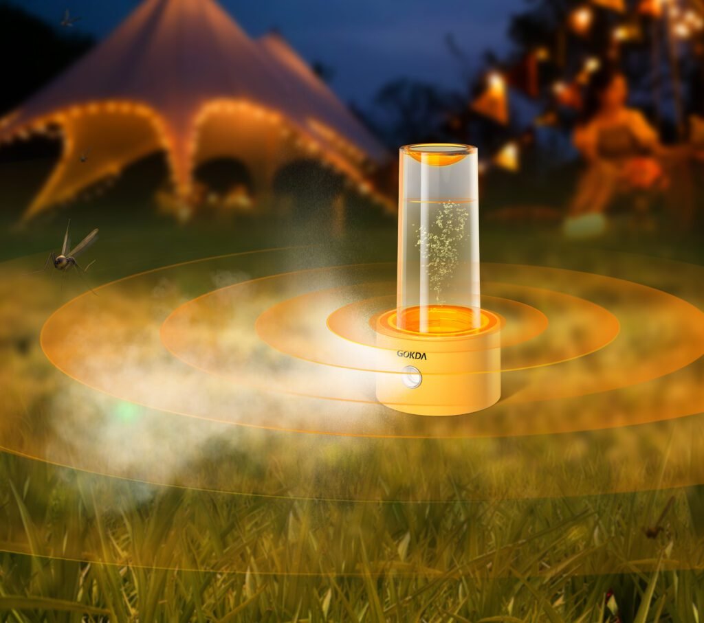 GOKDA Camping Essential: Portable Diffuser with Night Light & Mist GOKDA portable mosquito repellent diffuser in action at a night campsite, glowing with warm light and emitting aromatherapy mist against a background of illuminated tents.