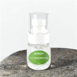 GOKDA Plant Aromatherapy mosquito repellent spray bottle sitting on a stone surface. Dual-use natural formula: works as a diffuser refill or direct body spray.